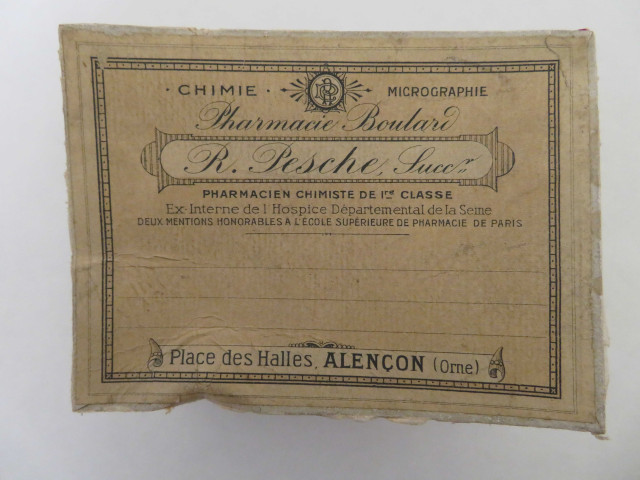 Boîte pharmaceutique rectangulaire de Raoul Pesche (couleur : blanc noir rouge) avec étiquette blanche et rose (12cm x 9cm x 7cm) (1902-1930).